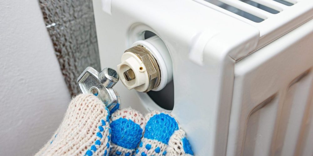 Radiator bleed key in plumber's hand.